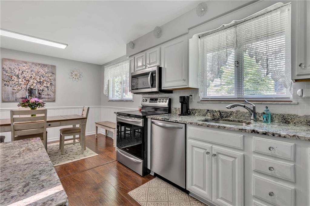 765 Catherine Street Rochester, PA 15074 - Photo 3 of 30 a kitchen with granite countertop a sink appliances cabinets and furniture