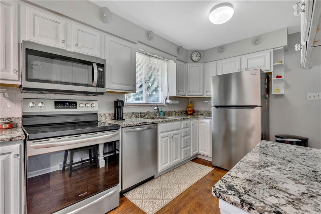 765 Catherine Street Rochester, PA 15074 - Photo 4 of 30 a kitchen with stainless steel appliances granite countertop a refrigerator stove and sink