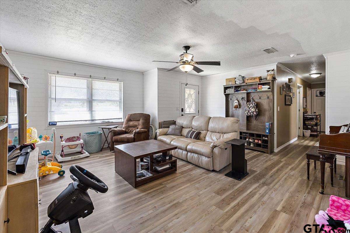 143 Lakeview Street Rusk, TX 75785 - Photo 9 of 28 a living room with furniture a flat screen tv and a large window