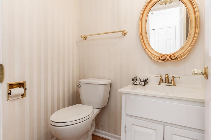 5792 Haddon Place Rockford, IL 61114 - Photo 23 of 47 a white toilet sitting next to a bathroom sink