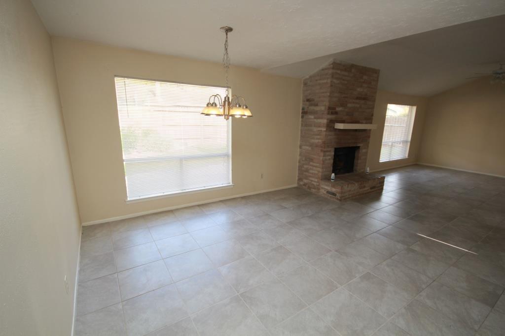 24002 Silversmith Lane Katy, TX 77493 - Photo 18 of 24 an empty room with windows and fireplace