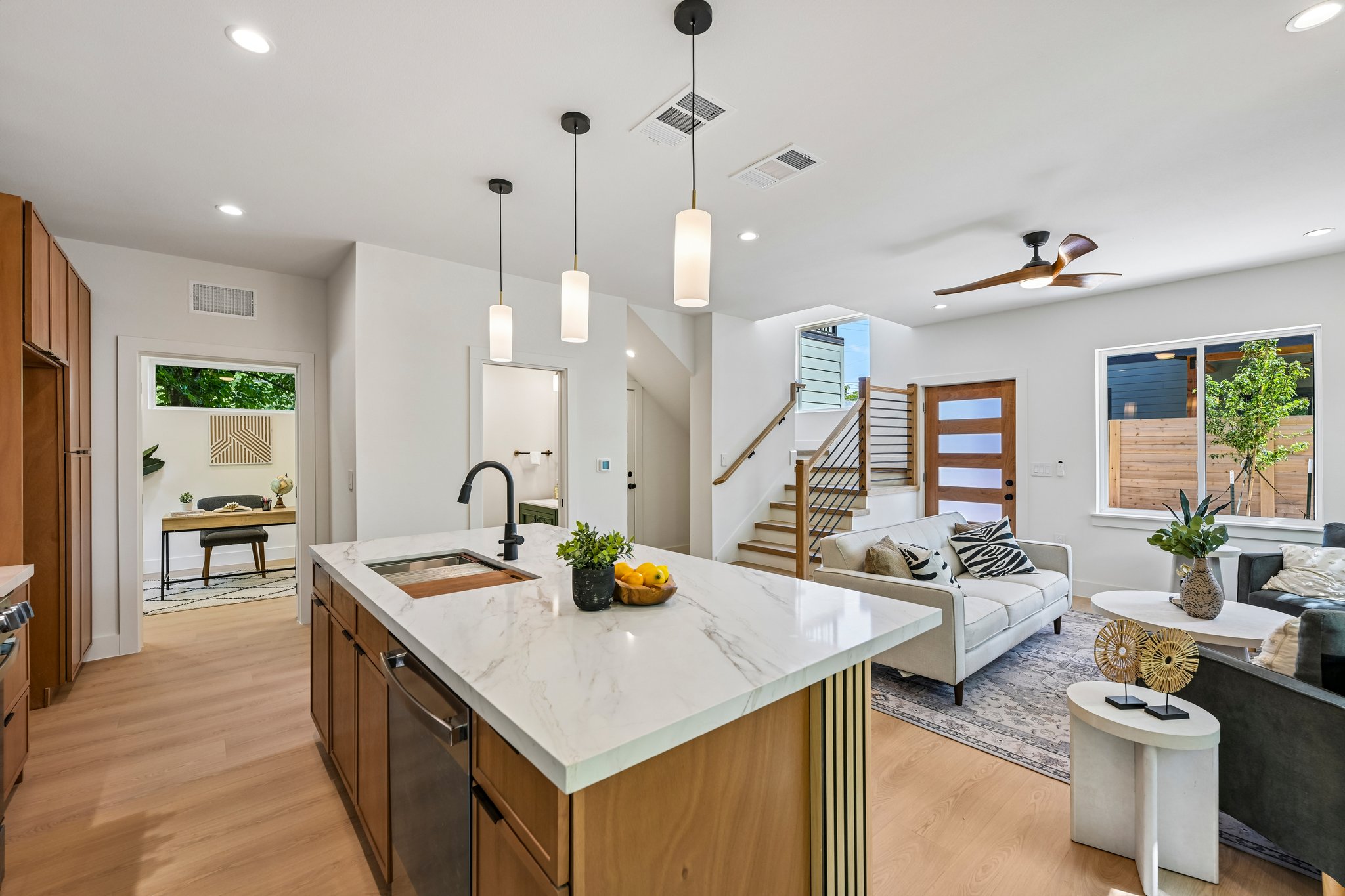513 West Odell Street, Unit B Austin, TX 78752 - Photo 14 of 38 An open concept living area showcases a large kitchen island and natural wood look floors.
