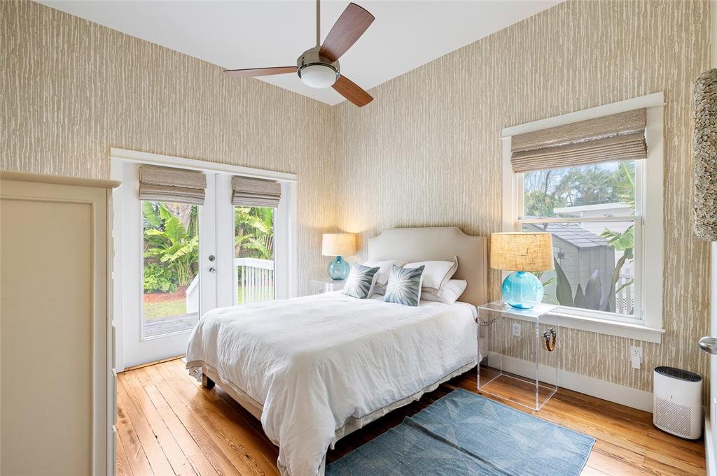 340 Palm Avenue Boca Grande, FL 33921 - Photo 21 of 38 a bedroom with a bed and a large window with outer view