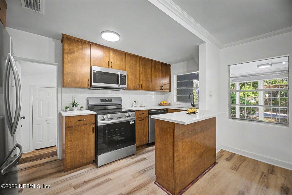 2520 Larsen Road Jacksonville, FL 32207 - Photo 12 of 27 a kitchen with stainless steel appliances granite countertop a stove top oven