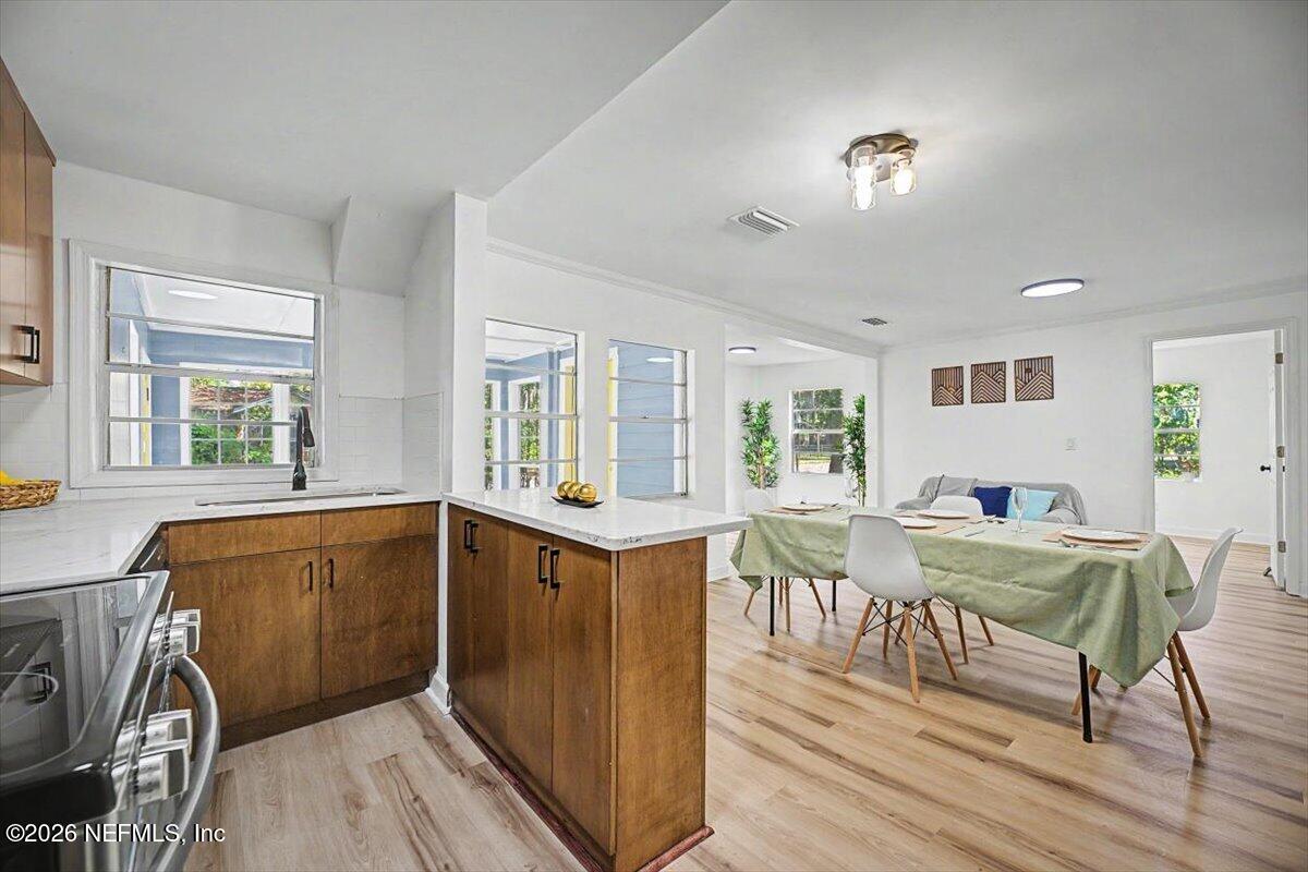 2520 Larsen Road Jacksonville, FL 32207 - Photo 14 of 27 a view of a dining room with furniture window and wooden floor