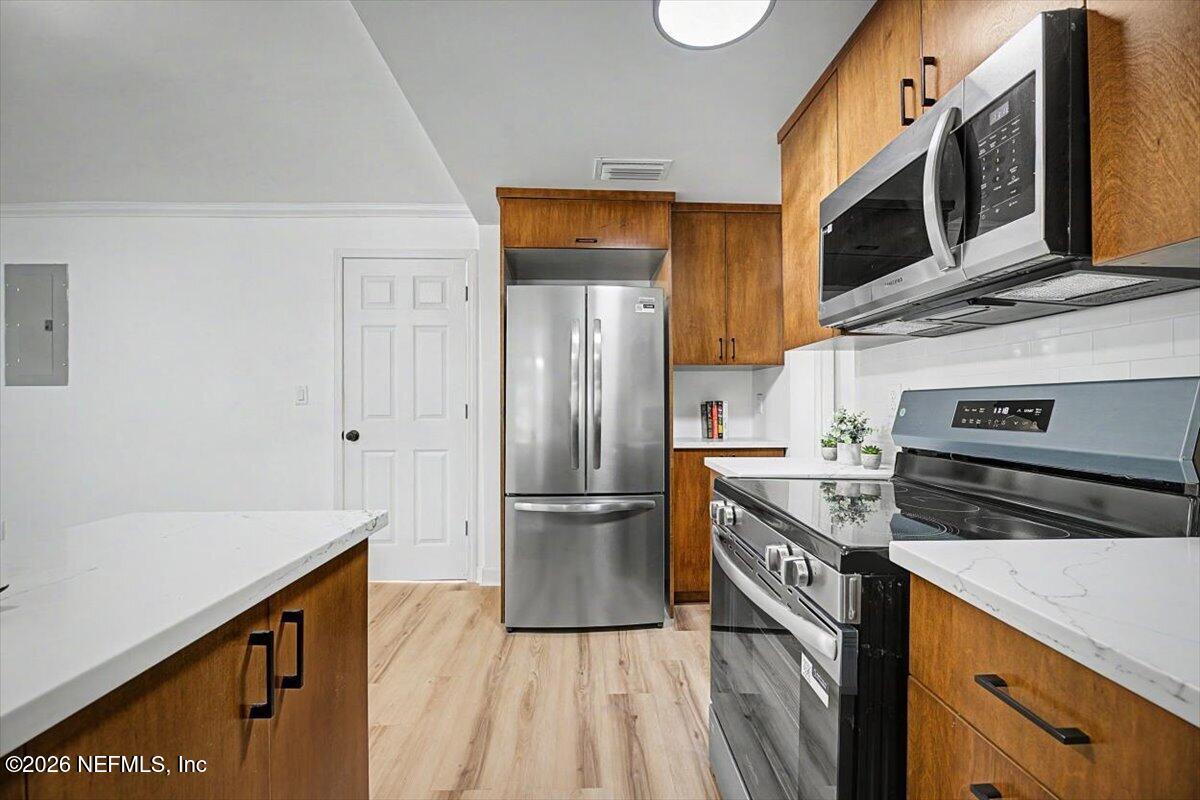 2520 Larsen Road Jacksonville, FL 32207 - Photo 15 of 27 a kitchen with stainless steel appliances granite countertop a refrigerator a stove and a sink