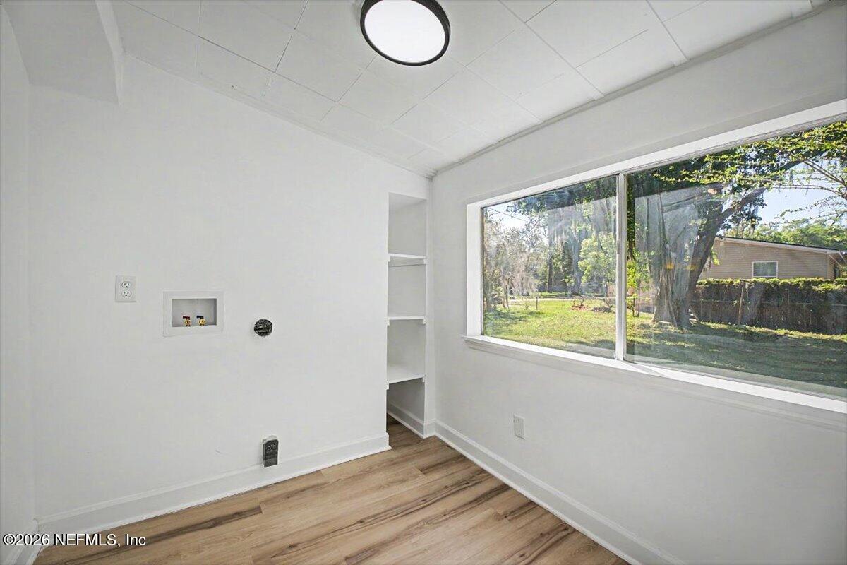 2520 Larsen Road Jacksonville, FL 32207 - Photo 20 of 27 an empty room with wooden floor and windows