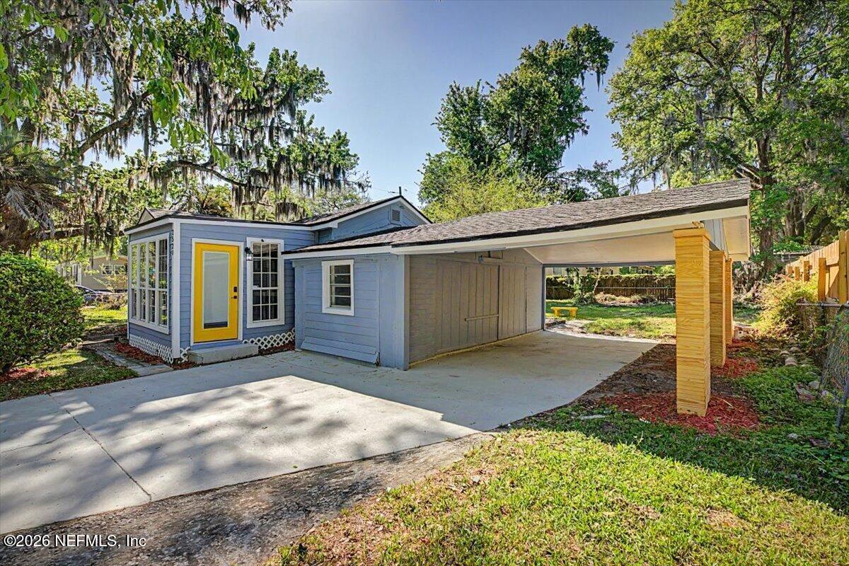 2520 Larsen Road Jacksonville, FL 32207 - Photo 2 of 27 a front view of a house with a yard and garage