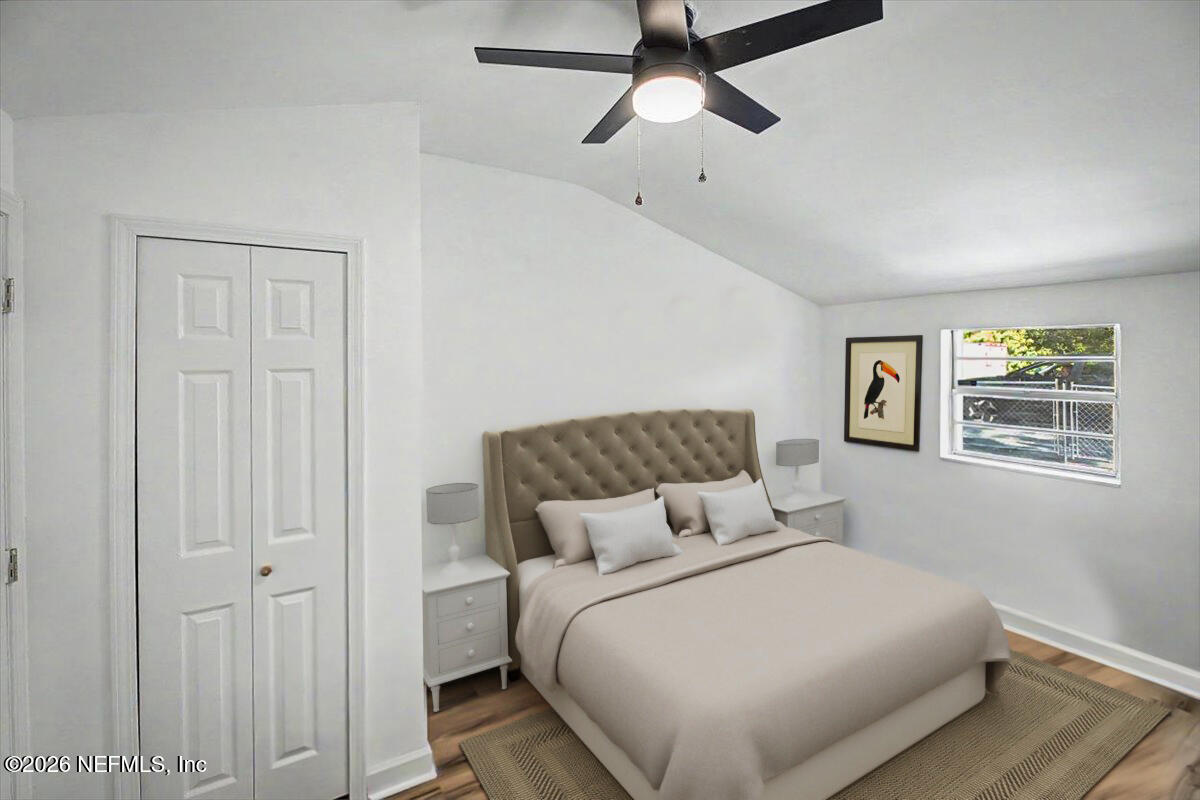 2520 Larsen Road Jacksonville, FL 32207 - Photo 21 of 27 a bedroom with a large bed and a chandelier