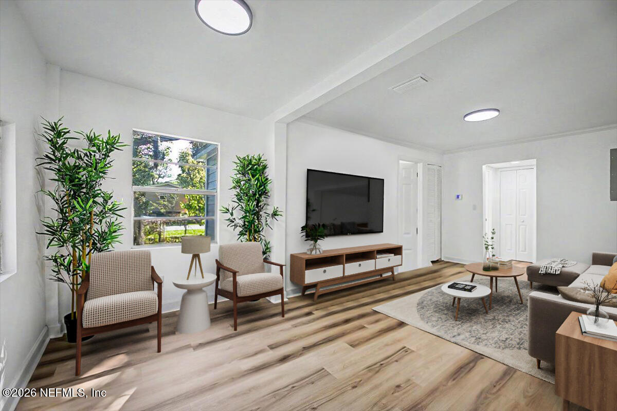 2520 Larsen Road Jacksonville, FL 32207 - Photo 7 of 27 a living room with furniture a flat screen tv and a large window