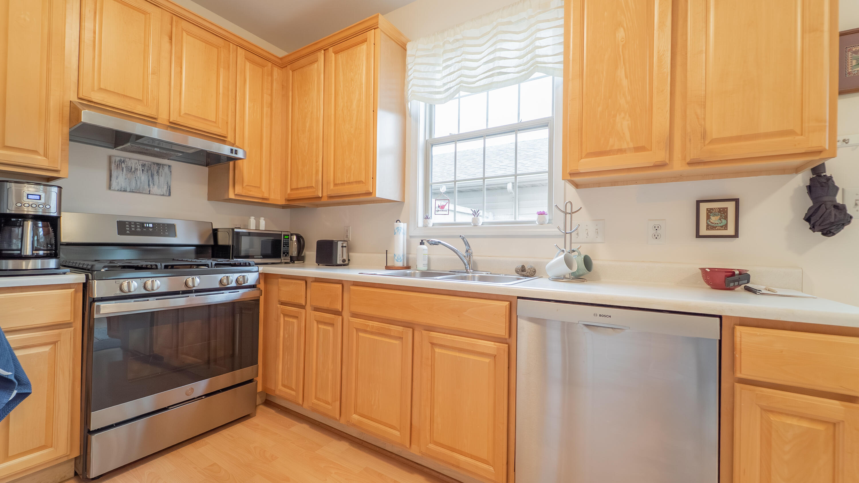 2898 Cambridge Way Highland, IN 46322 - Photo 8 of 22 a kitchen with granite countertop white cabinets stainless steel appliances a sink and window