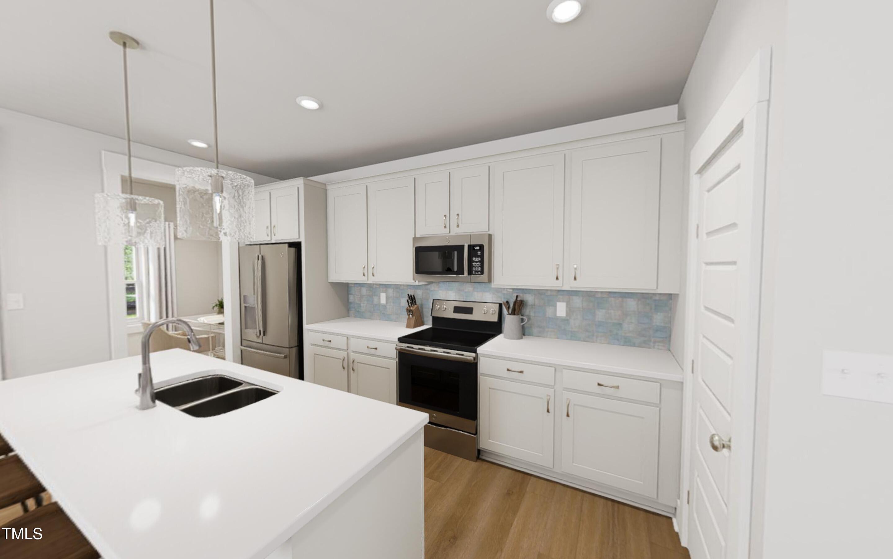 344 Cottage Hl Way Raleigh, NC 27604 - Photo 6 of 33 a kitchen with a sink a stove and refrigerator