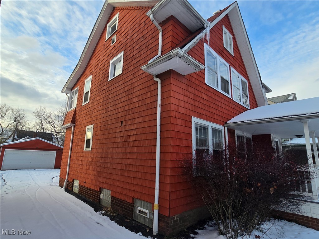 2048 Rossmoor Road Cleveland Heights, OH 44118 - Photo 2 of 29 View of snow covered exterior featuring a garage and an outdoor structure