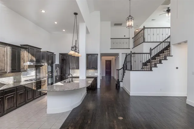 a view of a kitchen with cabinets and wooden floor