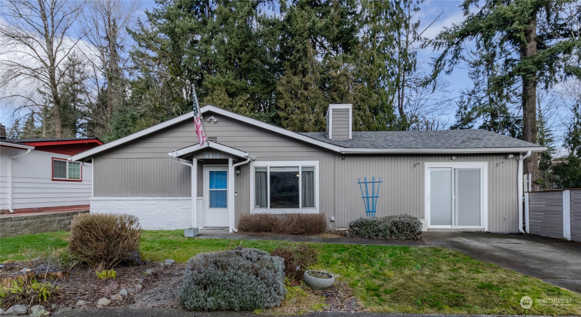 4512 Southeast 2nd Place Renton, WA 98059 - Photo 1 of 39 a view of a yard in front of a house with plants and large tree