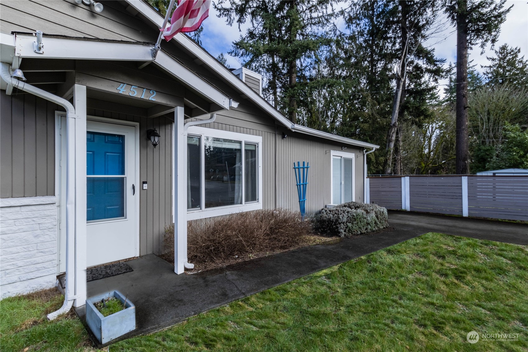4512 Southeast 2nd Place Renton, WA 98059 - Photo 4 of 39 a view of a backyard with plants and large tree