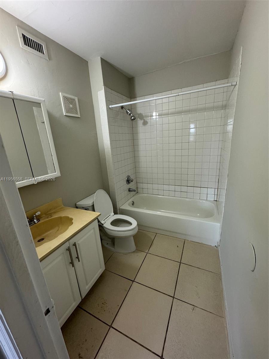 8060 Fairview Drive, Unit 201 Tamarac, FL 33321 - Photo 11 of 33 a bathroom with a granite countertop sink a toilet and shower