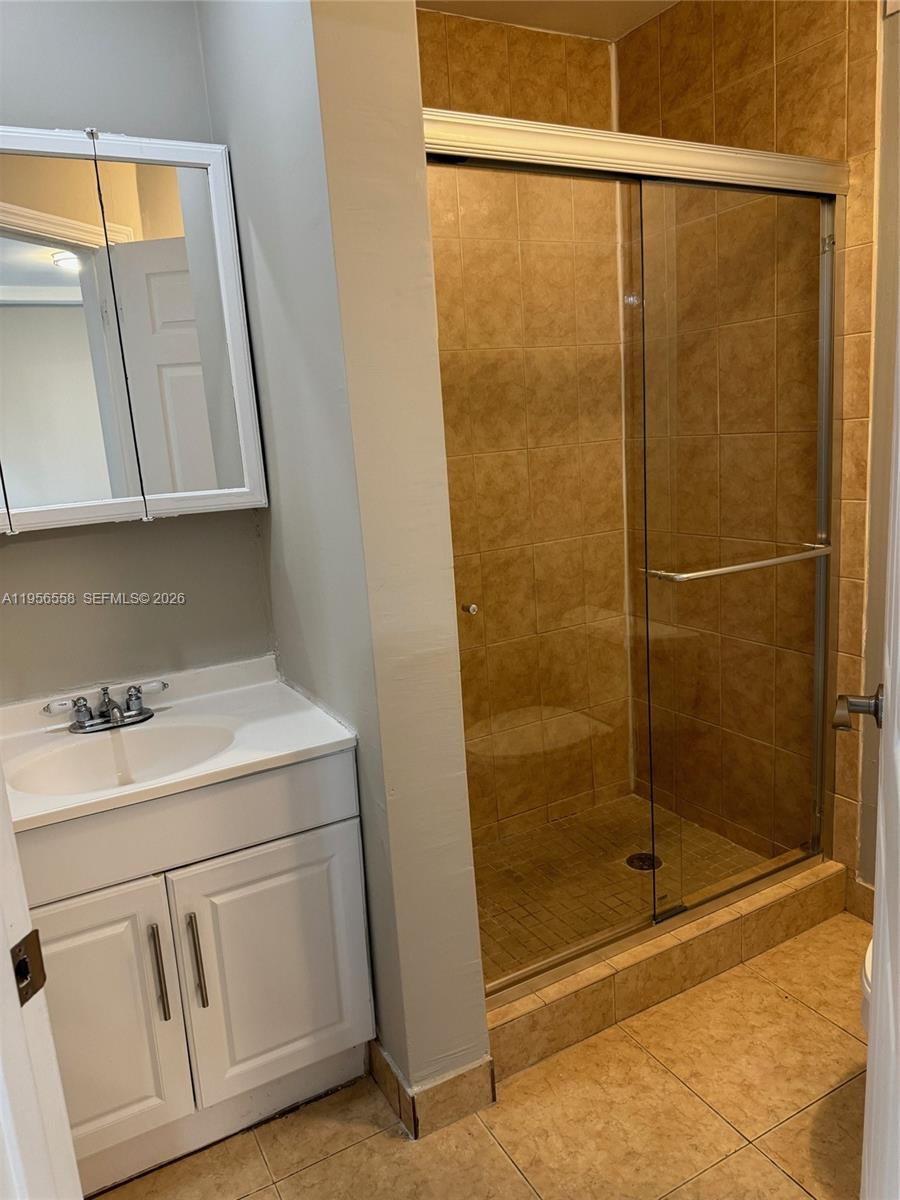 8060 Fairview Drive, Unit 201 Tamarac, FL 33321 - Photo 13 of 33 a bathroom with a sink and a shower