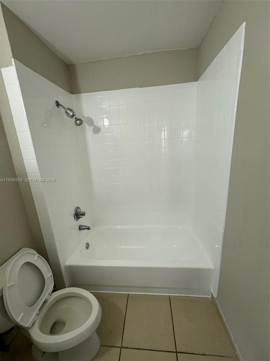 8060 Fairview Drive, Unit 201 Tamarac, FL 33321 - Photo 17 of 33 a bathroom with a granite countertop bathtub sink vanity mirror and toilet