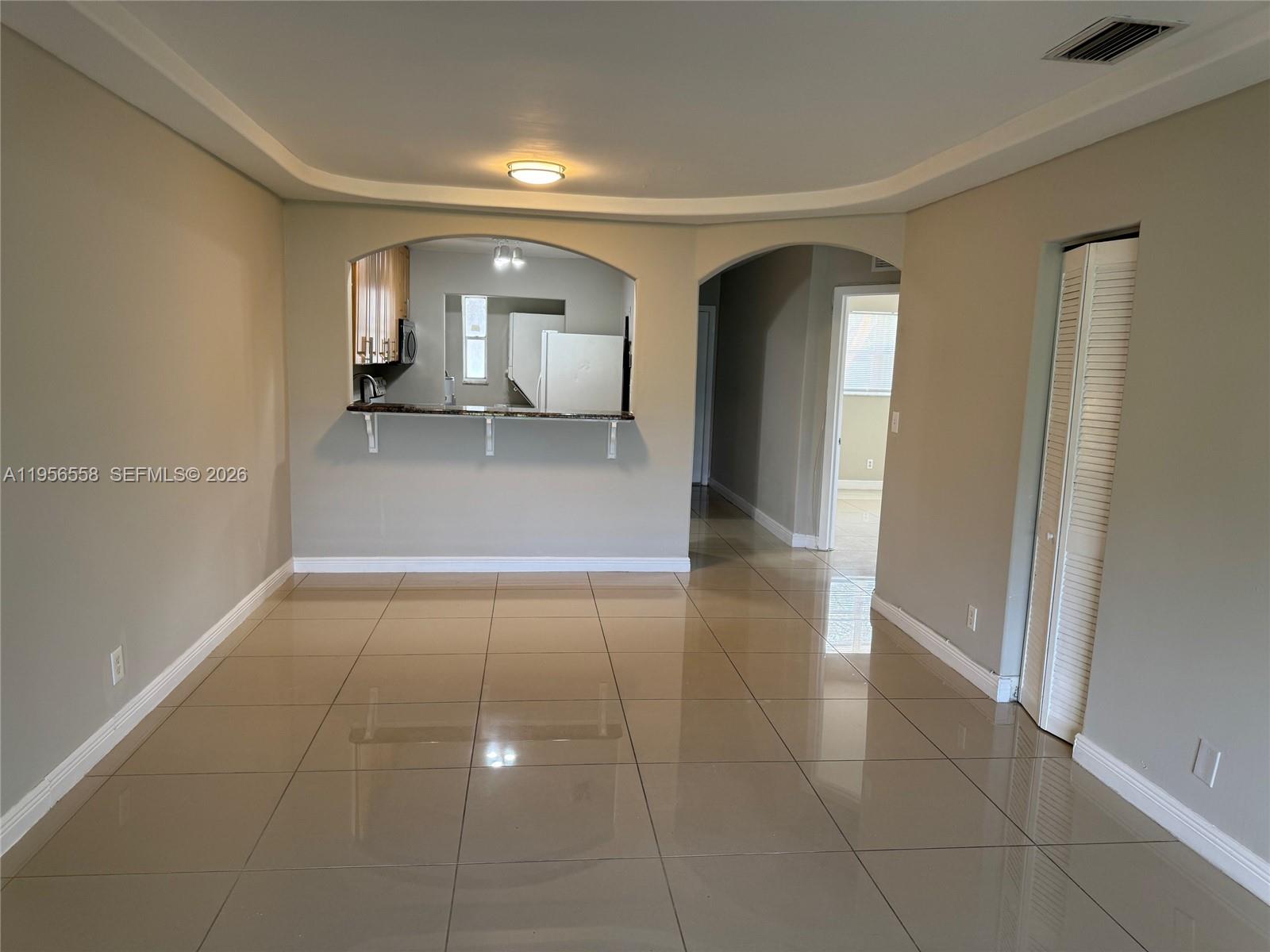 8060 Fairview Drive, Unit 201 Tamarac, FL 33321 - Photo 19 of 33 a view of a hallway with bathroom and a mirror