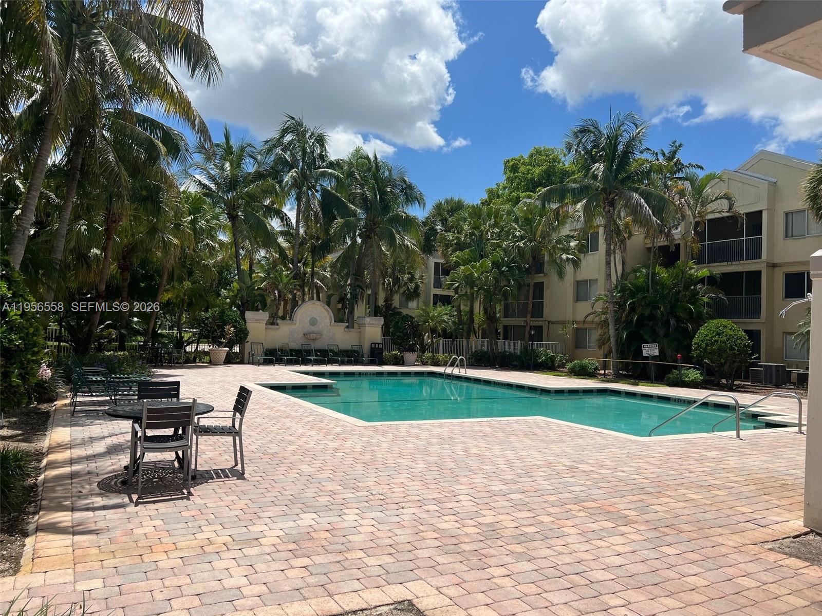 8060 Fairview Drive, Unit 201 Tamarac, FL 33321 - Photo 29 of 33 a swimming pool with barbeque oven and outdoor seating