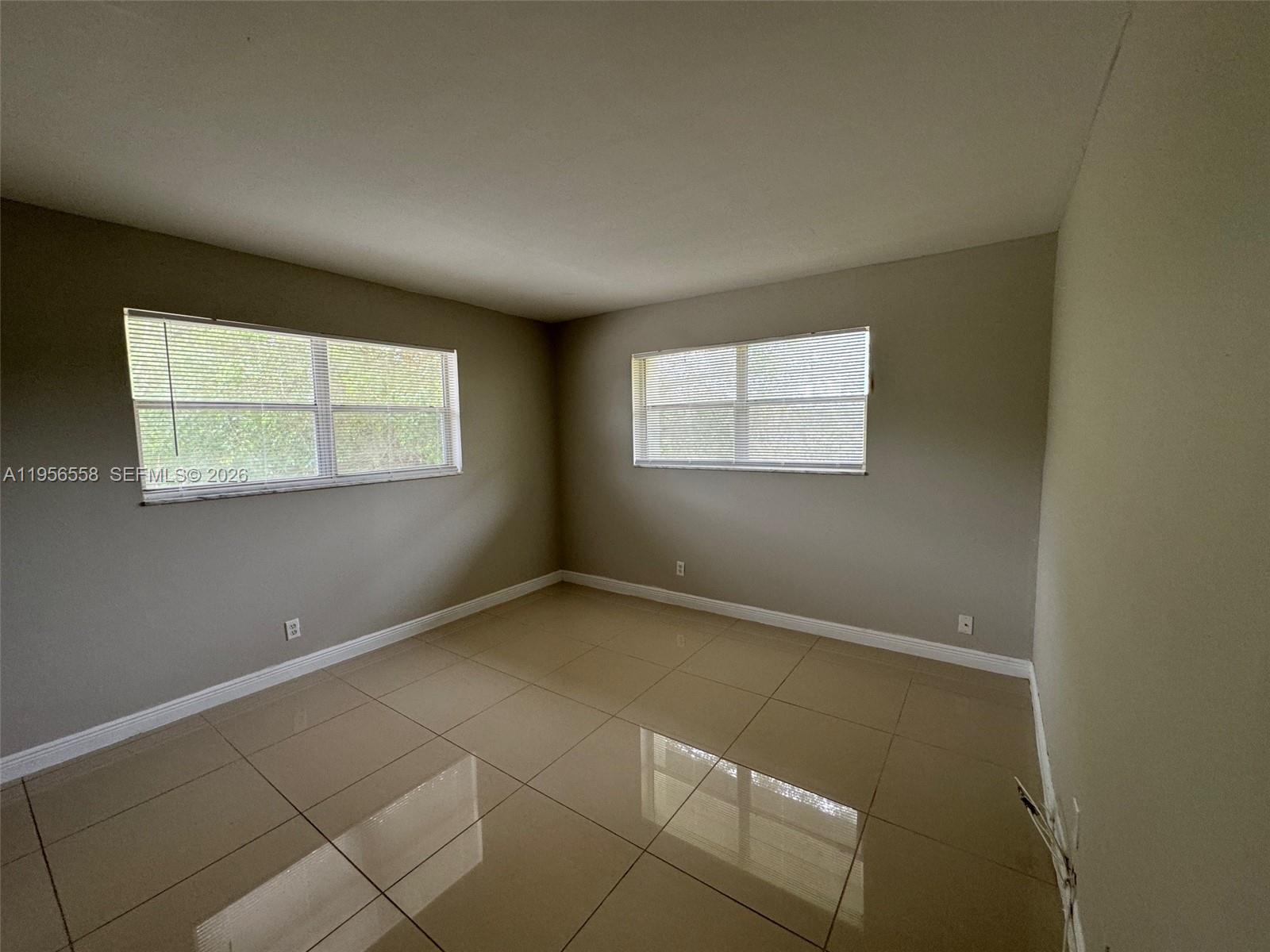 8060 Fairview Drive, Unit 201 Tamarac, FL 33321 - Photo 7 of 33 an empty room with windows