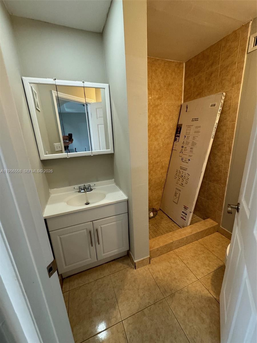 8060 Fairview Drive, Unit 201 Tamarac, FL 33321 - Photo 10 of 33 a bathroom with a sink and a mirror