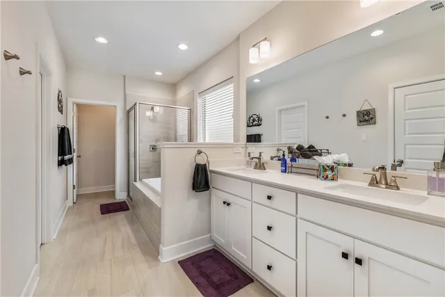 a large white kitchen with a sink and refrigerator