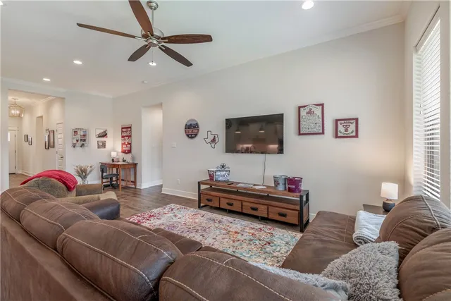 a kitchen with stainless steel appliances kitchen island granite countertop a table chairs sink and cabinets