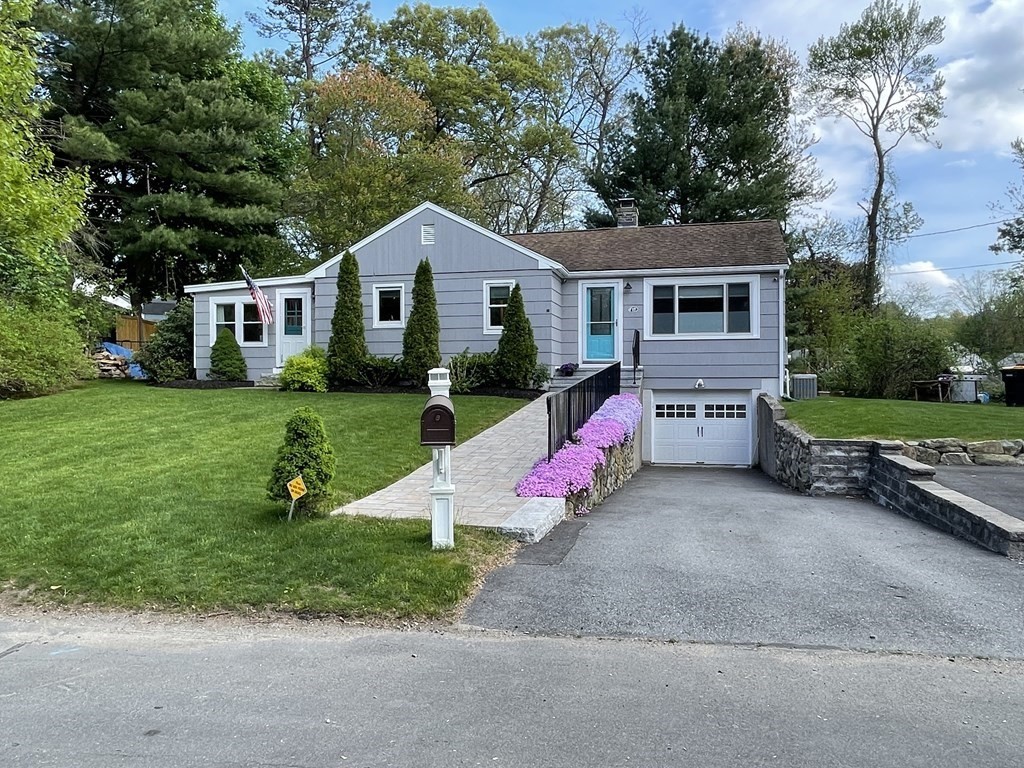 a front view of house with yard and green space