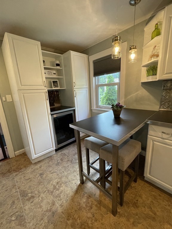 17 Audrea Road Framingham, MA 01701 - Photo 8 of 27 a kitchen with stainless steel appliances a table chairs and a refrigerator