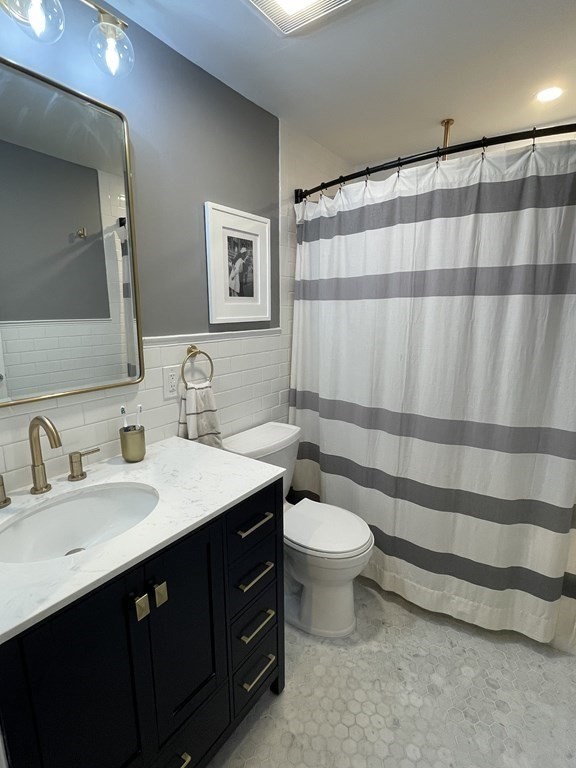 17 Audrea Road Framingham, MA 01701 - Photo 10 of 27 a bathroom with a double sink toilet a mirror and shower