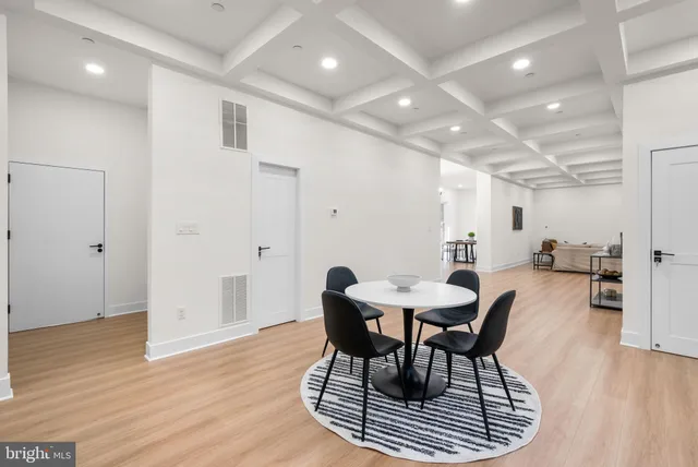 a kitchen with stainless steel appliances granite countertop a refrigerator a stove a sink dishwasher a dining table and chairs