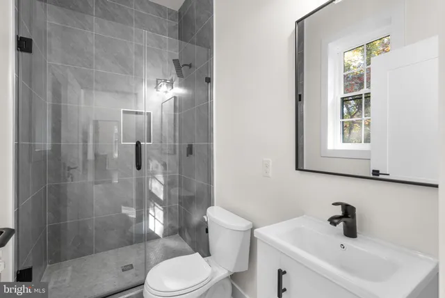 a bathroom with a toilet a sink a bathtub and a mirror