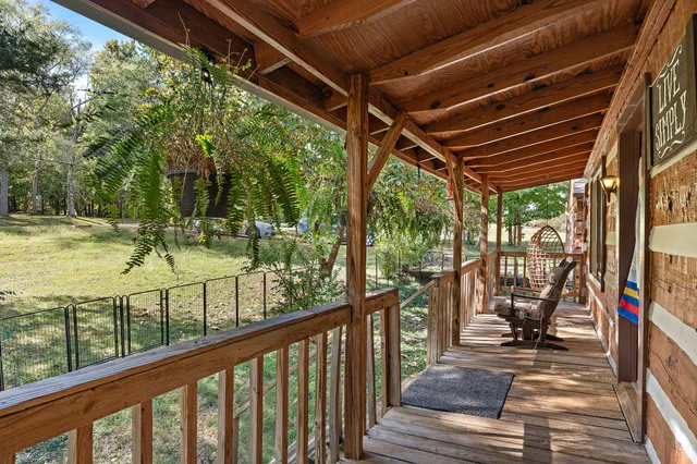 a view of a porch with wooden floor and outdoor space