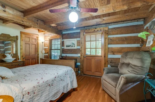 a bedroom with a bed and wooden floor