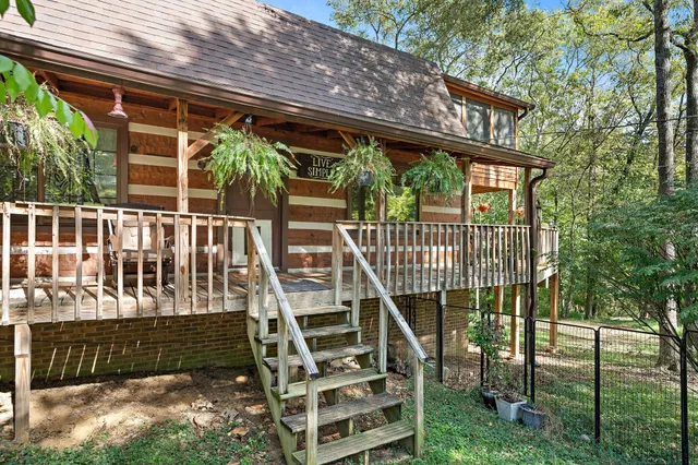 a view of a wooden deck with a yard