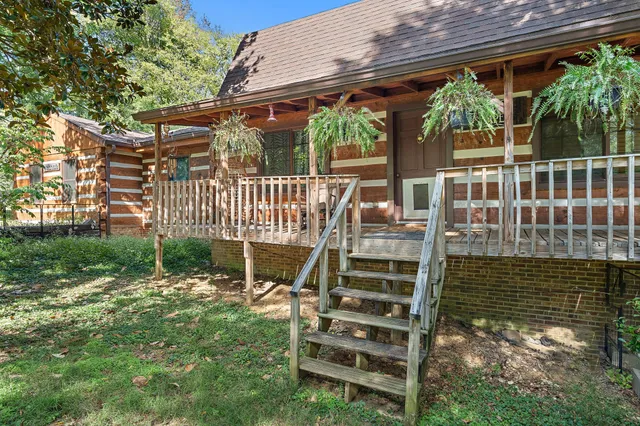 a view of a chair and table in backyard of the house