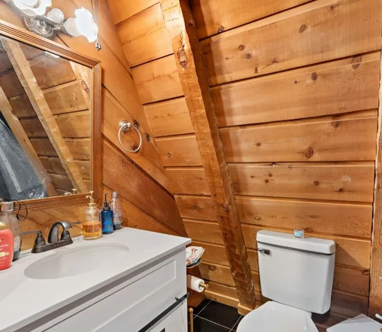 a bathroom with a blue sink and a toilet