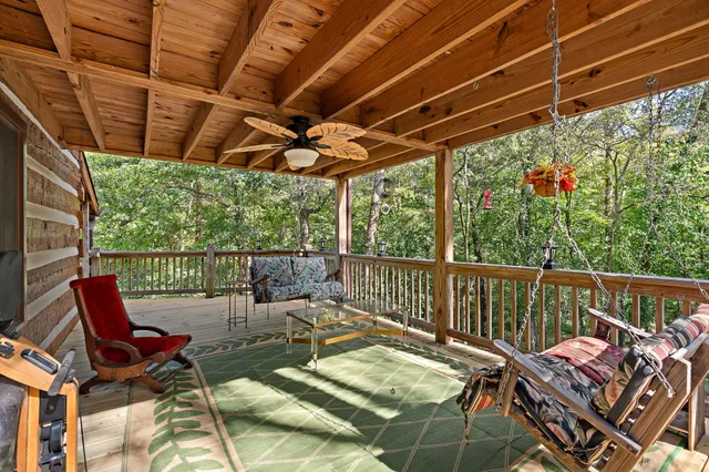 a view of a chairs and table in patio with wooden fence