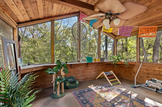 a view of porch with a table and chairs