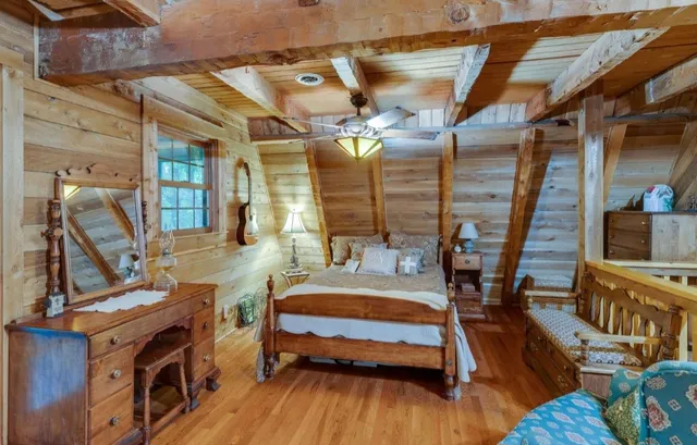 a bedroom with furniture and a wooden floor