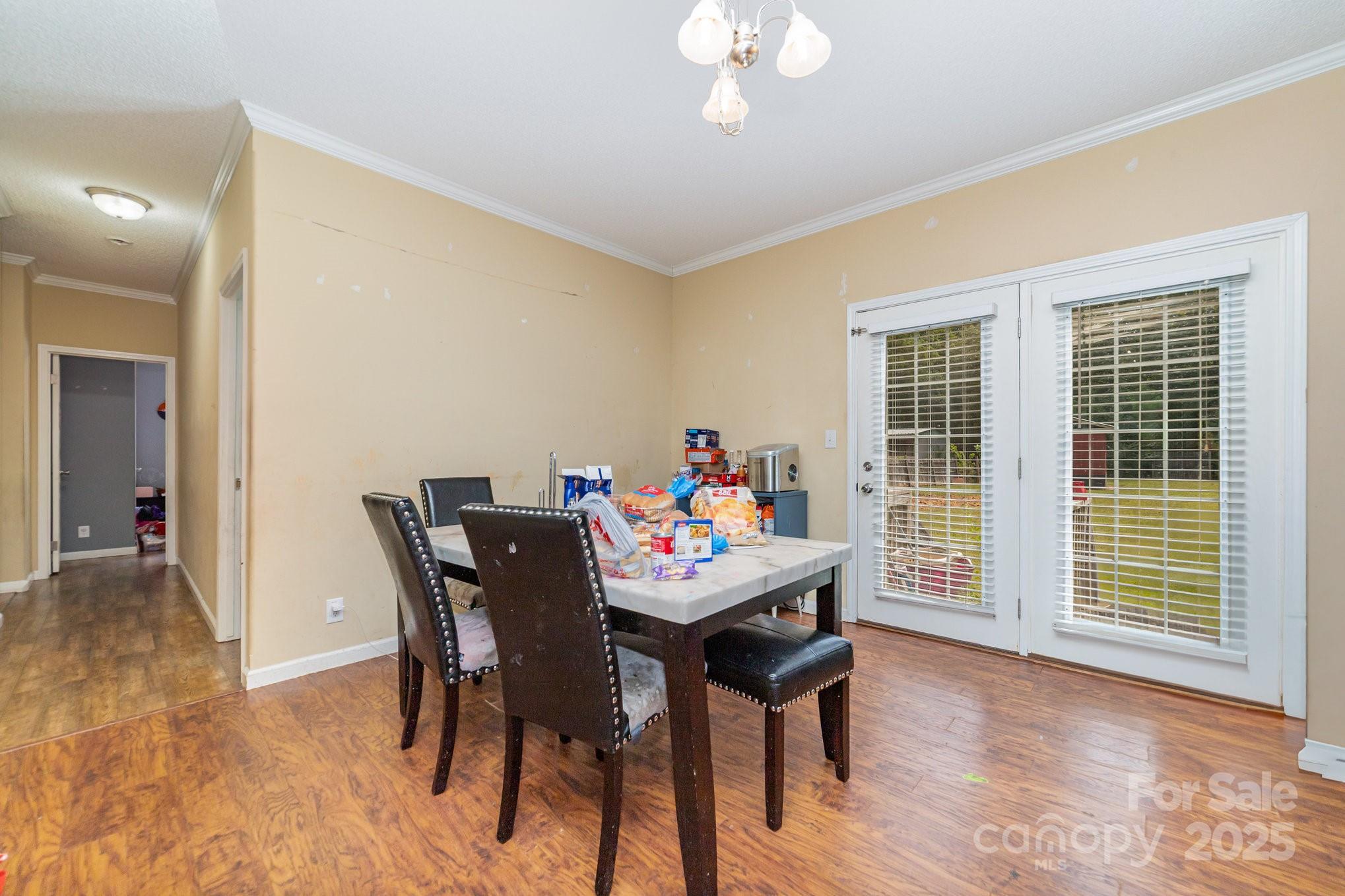 1206 Old Friendship Road Rock Hill, SC 29730 - Photo 3 of 8 a dining room with furniture a rug and a chandelier