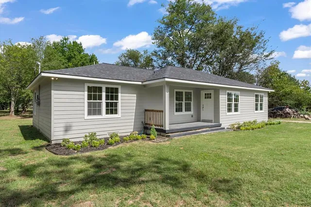 a front view of house with yard and green space