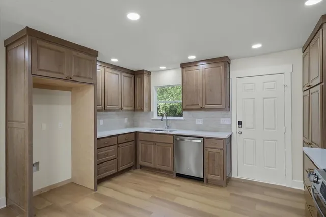 a kitchen with stainless steel appliances granite countertop a refrigerator and a sink
