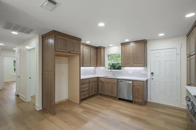 a bathroom with a granite countertop sink mirror and shower