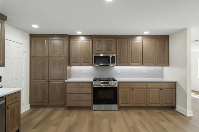 a kitchen with stainless steel appliances granite countertop a stove and a refrigerator
