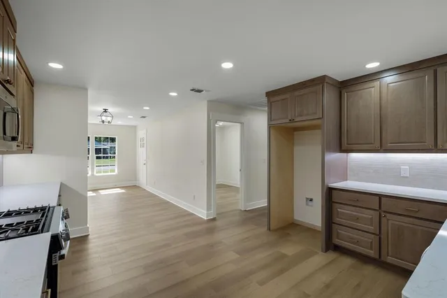 a view of kitchen with furniture and wooden floor