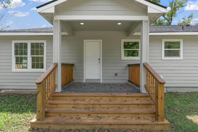 a front view of house with wooden stairs