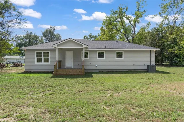 a front view of house with yard and trees